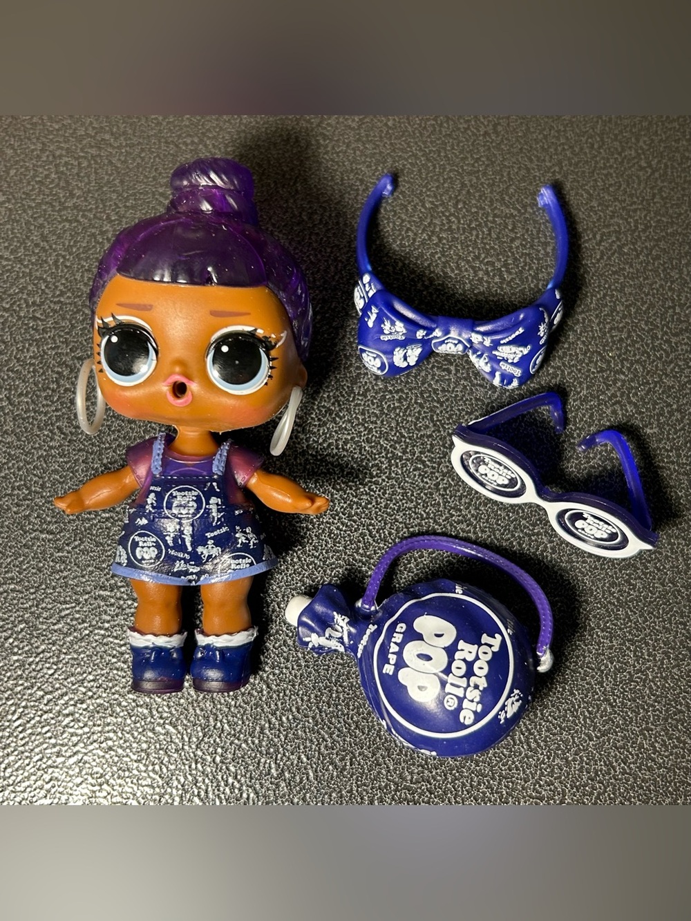 L.O.L. Surprise! Doll with Purple Hair and Dark Blue Outfit Tootsie Roll Pop